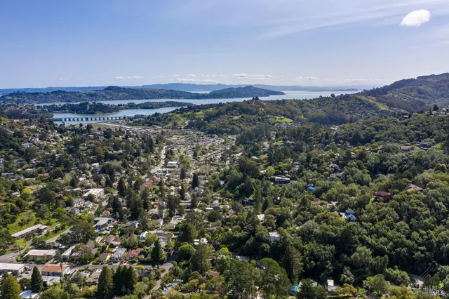 an aerial view of a house with a yard swimming pool and outdoor seating