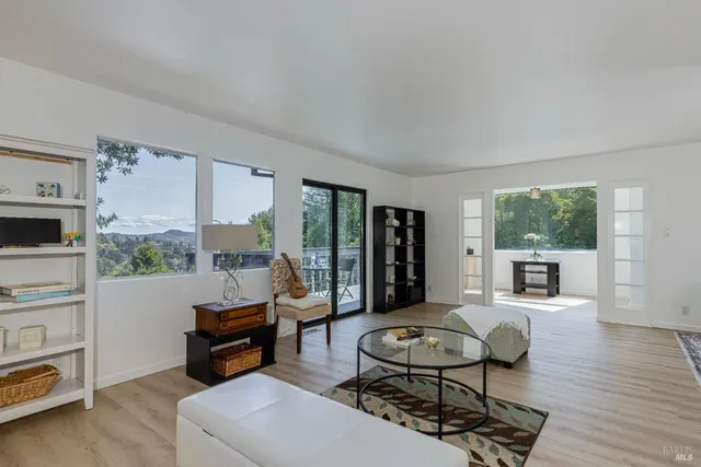 a kitchen with stainless steel appliances a stove a microwave a sink and white cabinets