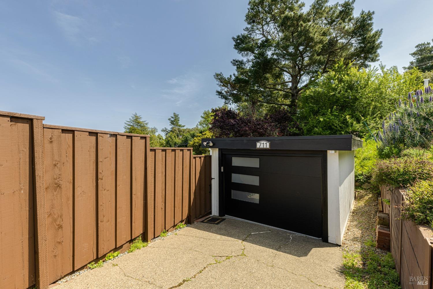 711 Alta Vista Road Mill Valley, CA 94941 - Photo 63 of 74 Enclosed modern looking garage with new garage door and opener. Paved driveway parking for additional car's along with bonus parking on unpaved gravel driveway on side of garage.