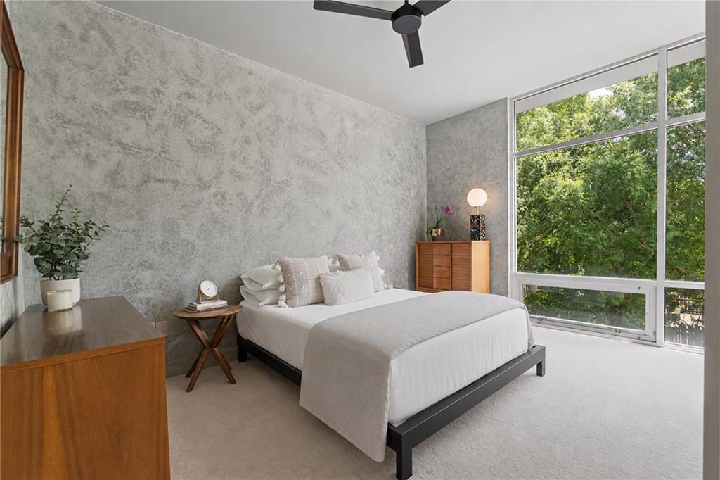 752 Moreland Avenue Southeast, Unit 4 Atlanta, GA 30316 - Photo 34 of 58 a bedroom with a bed and a table in it