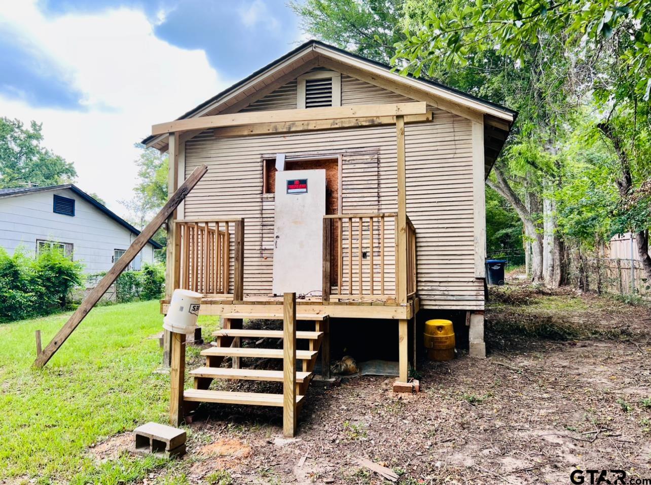 1205 North Third Street Longview, TX 75601 - Photo 18 of 25 a front view of a house with a yard