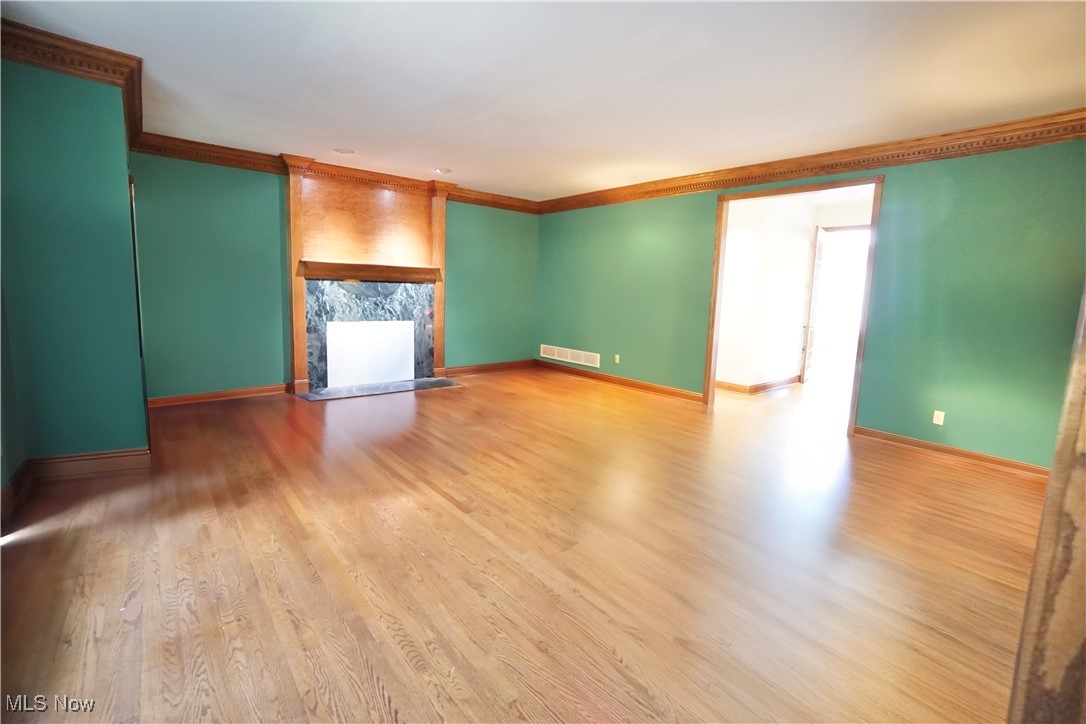 7060 Gates Road Gates Mills, OH 44040 - Photo 14 of 38 Unfurnished living room with crown molding, wood finished floors, and a fireplace