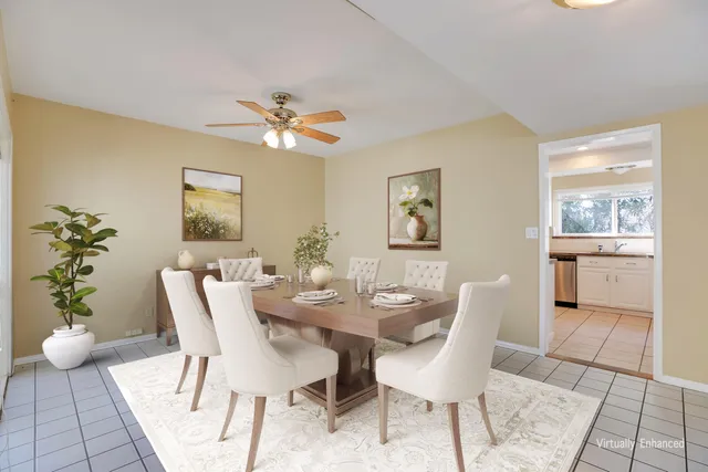 a view of a dining room with furniture and a potted plant