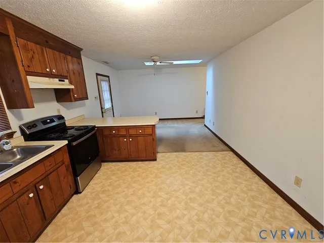 a kitchen with granite countertop a sink and cabinets