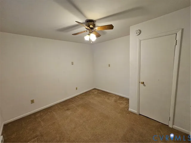 a view of an empty room with a fan