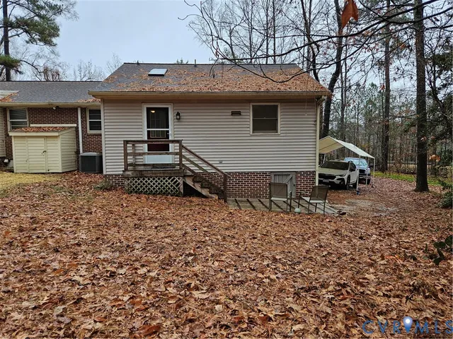 a view of a house with a yard and wooden fence