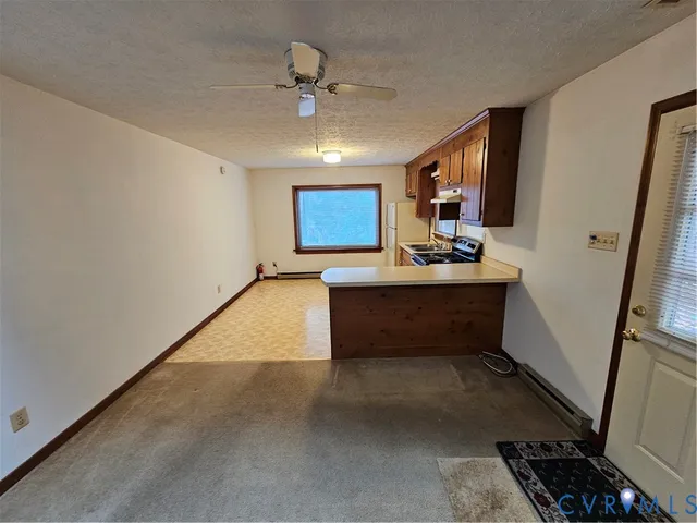 a hallway with a large window and chandelier