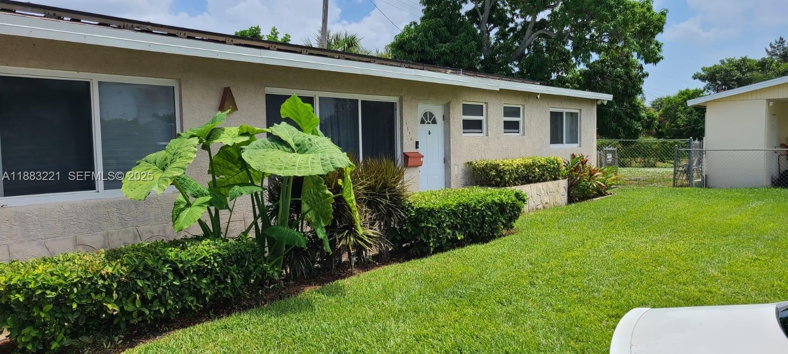 1556 Evergreen Court Riviera Beach, FL 33404 - Photo 2 of 2 a view of a back yard of the house