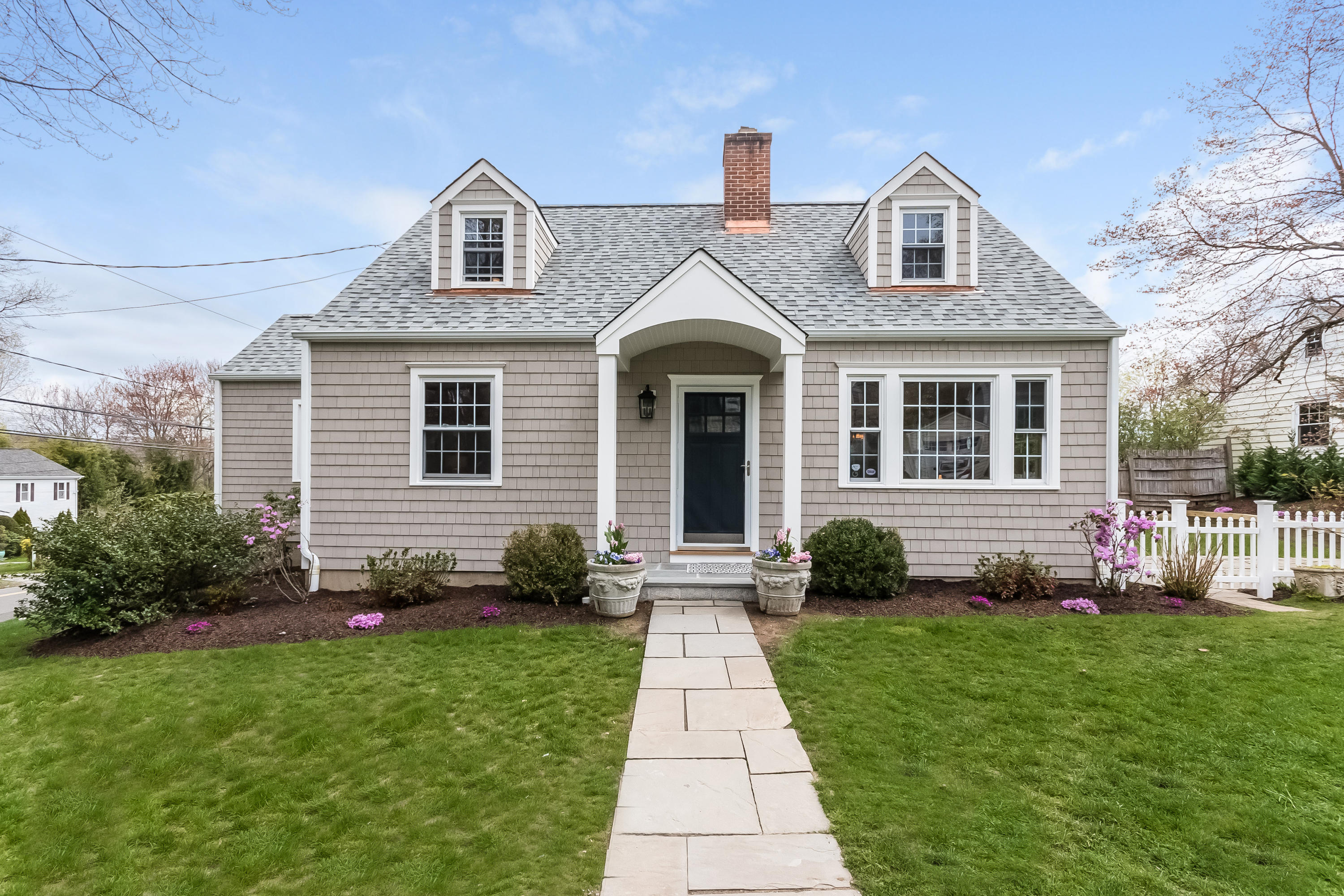 1 Walmsley Road Darien, CT 06820 - Photo 1 of 27 a front view of a house with a yard and potted plants