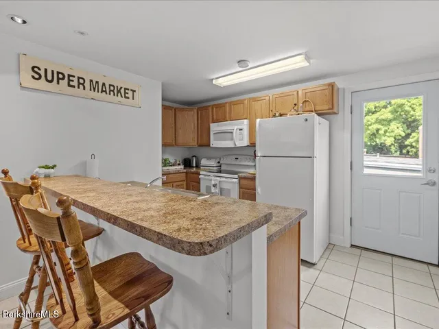 a kitchen with a refrigerator a stove a sink and a refrigerator