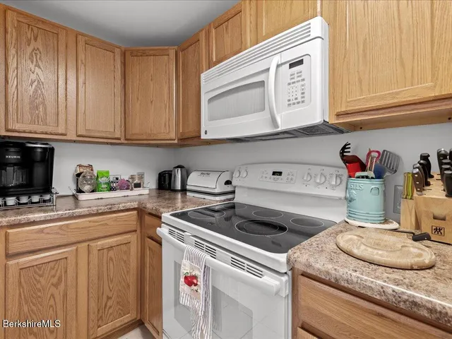 a kitchen with granite countertop cabinets washer and dryer