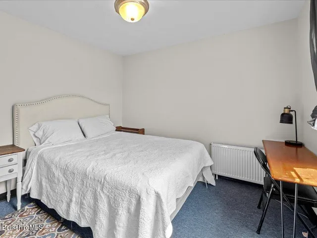 a bedroom with a bed and chair