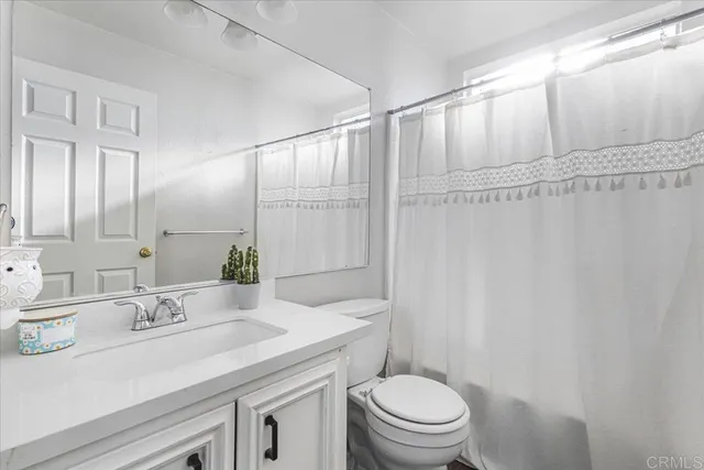 a view of an empty room with a kitchen