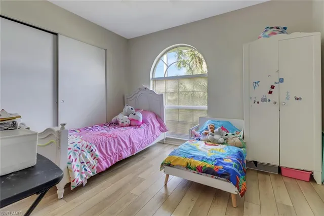 a bedroom with bed and a window