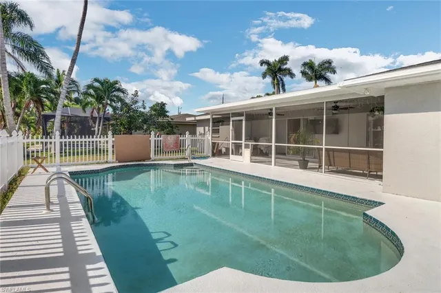 a view of a swimming pool with a lounge chairs