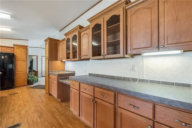 a kitchen with stainless steel appliances granite countertop a sink and cabinets