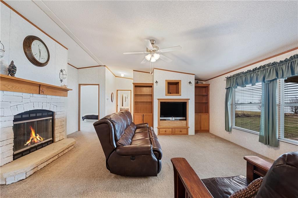 260 Lcr 751 Road Thornton, TX 76687 - Photo 14 of 40 a living room with furniture a fireplace and a flat screen tv