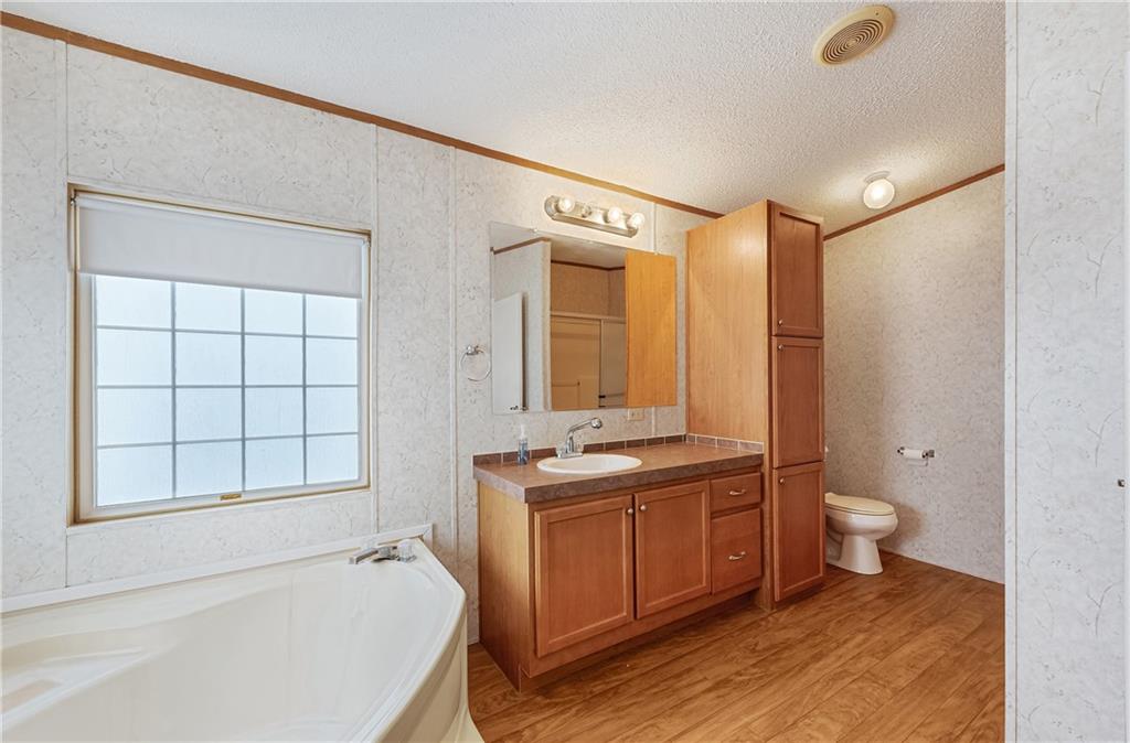 260 Lcr 751 Road Thornton, TX 76687 - Photo 19 of 40 a bathroom with a granite countertop sink toilet and shower