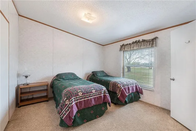 a bedroom with two beds and a window