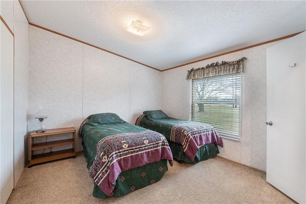260 Lcr 751 Road Thornton, TX 76687 - Photo 23 of 40 a bedroom with two beds and a window