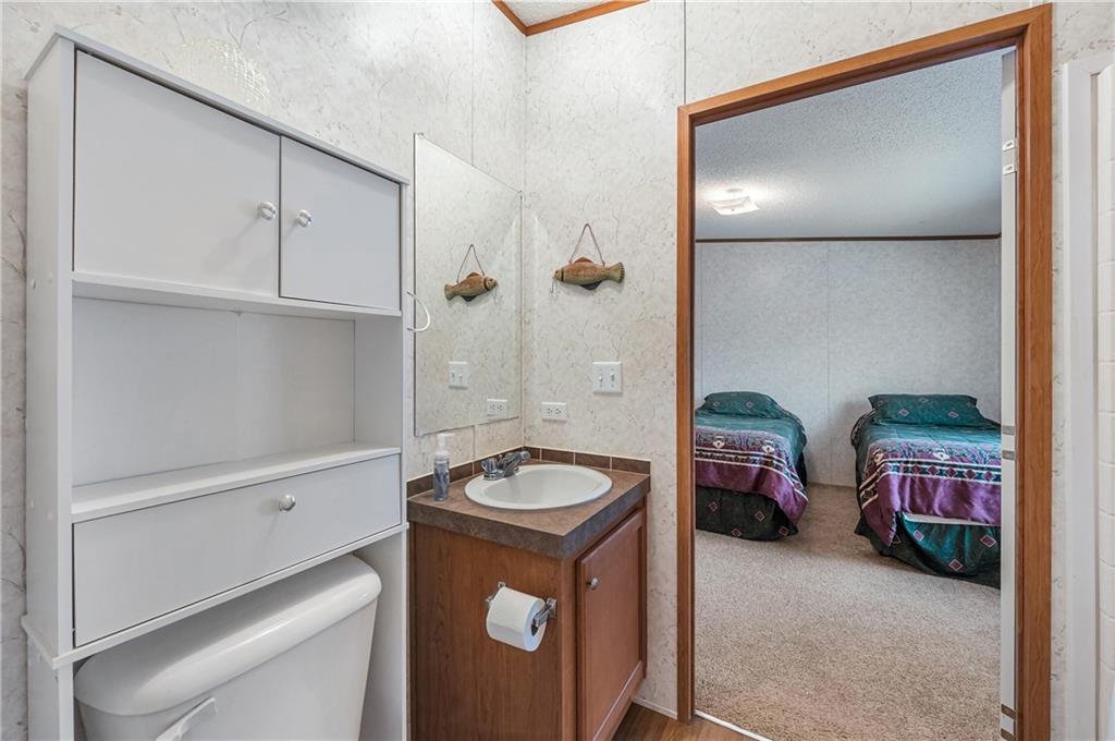 260 Lcr 751 Road Thornton, TX 76687 - Photo 26 of 40 a bathroom with a granite countertop sink and a mirror