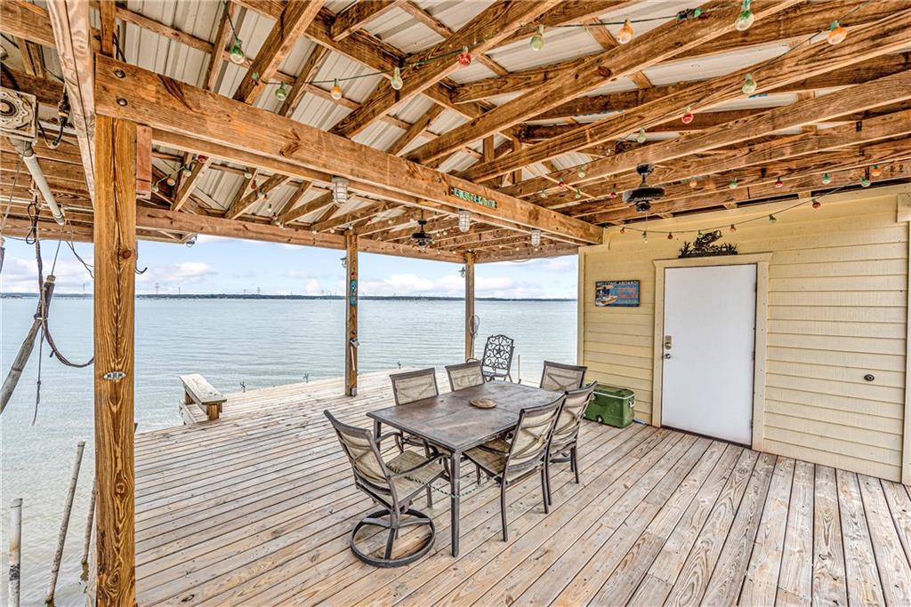 260 Lcr 751 Road Thornton, TX 76687 - Photo 33 of 40 a view of a patio with table and chairs and wooden floor