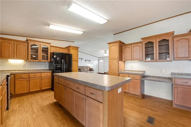 a kitchen with stainless steel appliances granite countertop a sink and cabinets