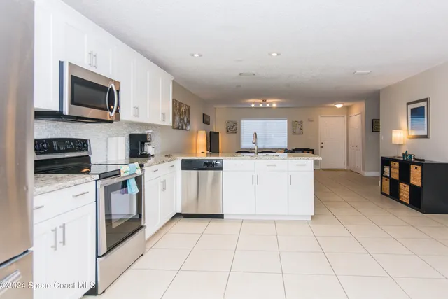 a kitchen with cabinets and appliances