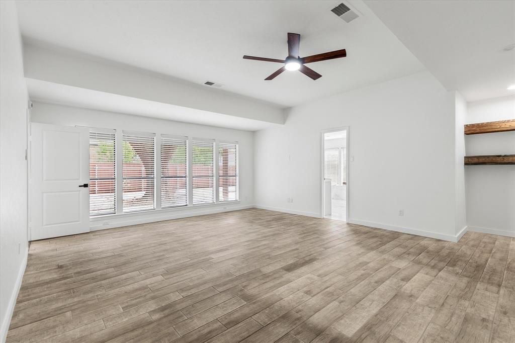 17003 Davenport Road Dallas, TX 75248 - Photo 20 of 40 a view of an empty room with a window and wooden floor