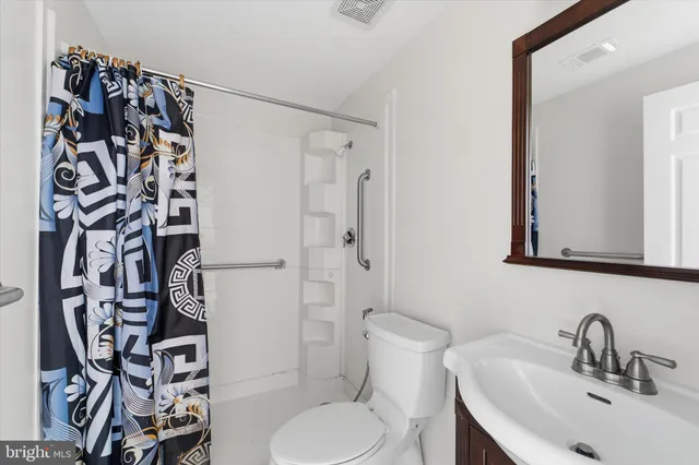 a view of a pathway of a yard with wooden fence