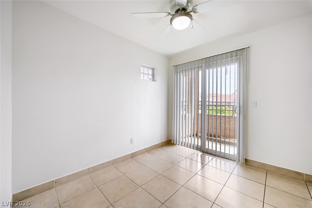 9325 West Desert Inn Road, Unit 177 Las Vegas, NV 89117 - Photo 10 of 24 A well-lit bedroom with direct outdoor access and tiled flooring for effortless upkeep.