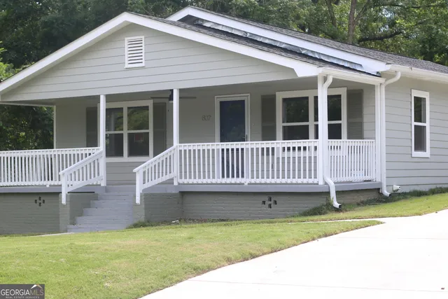 a view of a house with a yard and deck