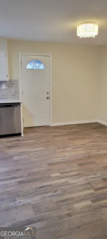 a large kitchen with granite countertop a stove and a sink