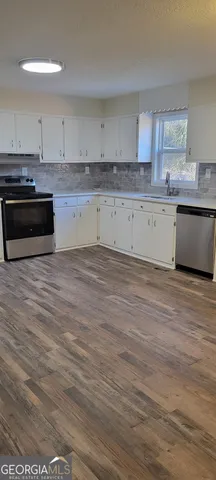 a view of a kitchen with electric appliances