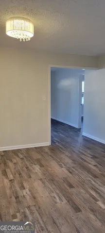 a view of a room with wooden floor and window
