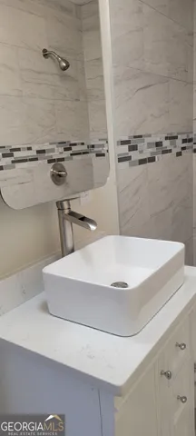 a view of an empty room with wooden floor and window