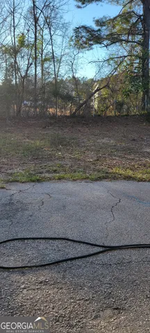 a view of a small house with a yard
