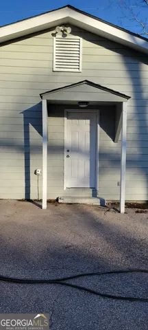 a view of a house with a yard and sitting area