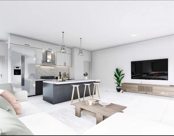 a living room with furniture a flat screen tv and kitchen view