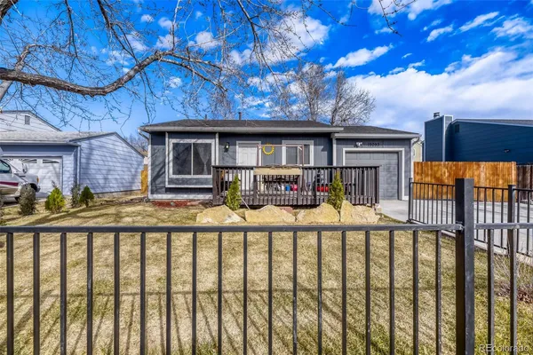 a view of a house with wooden fence