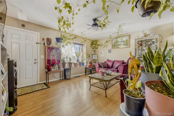 a living room with furniture and wooden floor