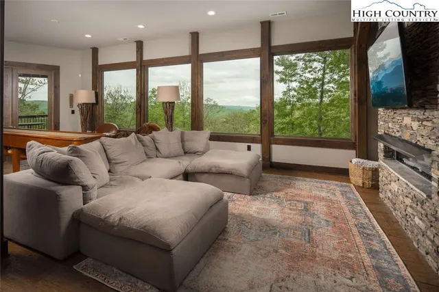 a living room with furniture and a floor to ceiling window