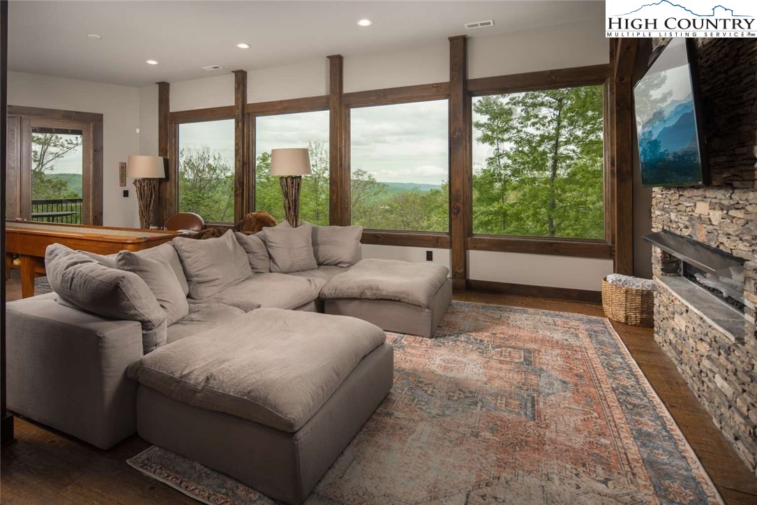 856 Ninebark Road Boone, NC 28607 - Photo 12 of 30 a living room with furniture and a floor to ceiling window