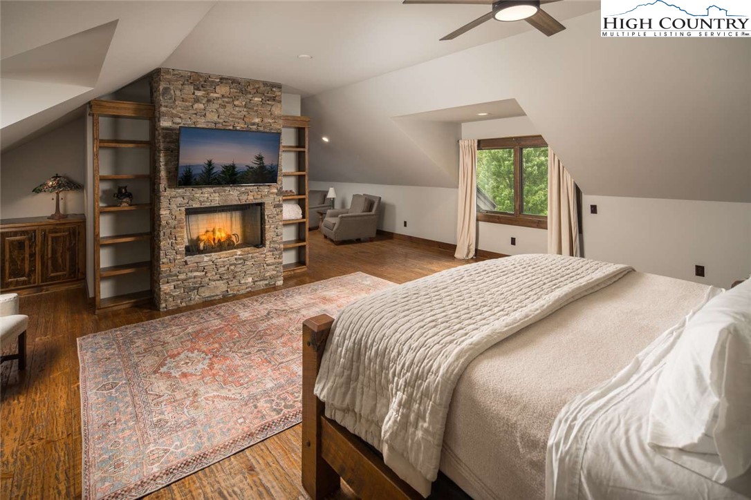 856 Ninebark Road Boone, NC 28607 - Photo 20 of 30 a bedroom with a bed and a flat screen tv