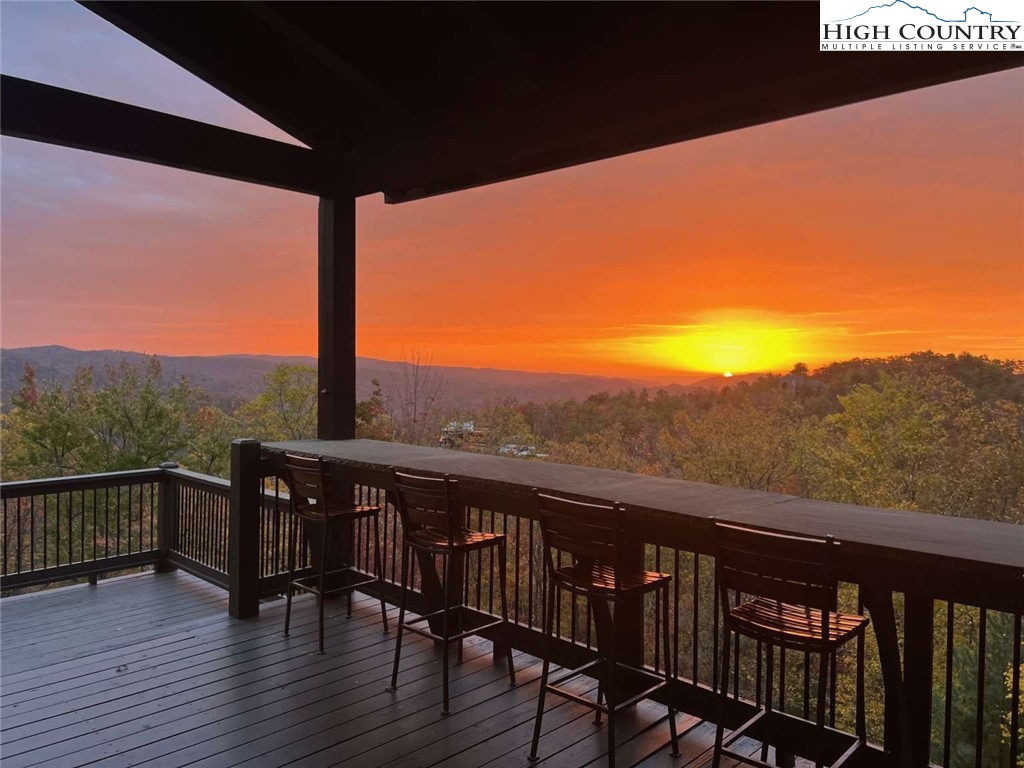856 Ninebark Road Boone, NC 28607 - Photo 2 of 30 a view of a balcony with wooden floor and fence