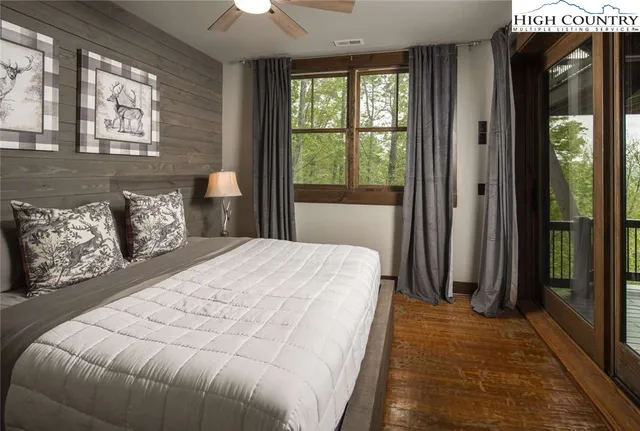 a bedroom with a large bed and a large window