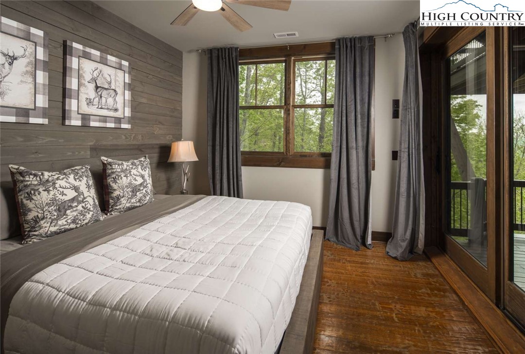 856 Ninebark Road Boone, NC 28607 - Photo 21 of 30 a bedroom with a large bed and a large window
