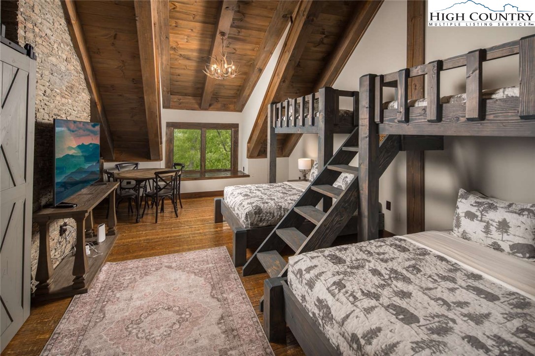 856 Ninebark Road Boone, NC 28607 - Photo 22 of 30 a bedroom with furniture and a large window