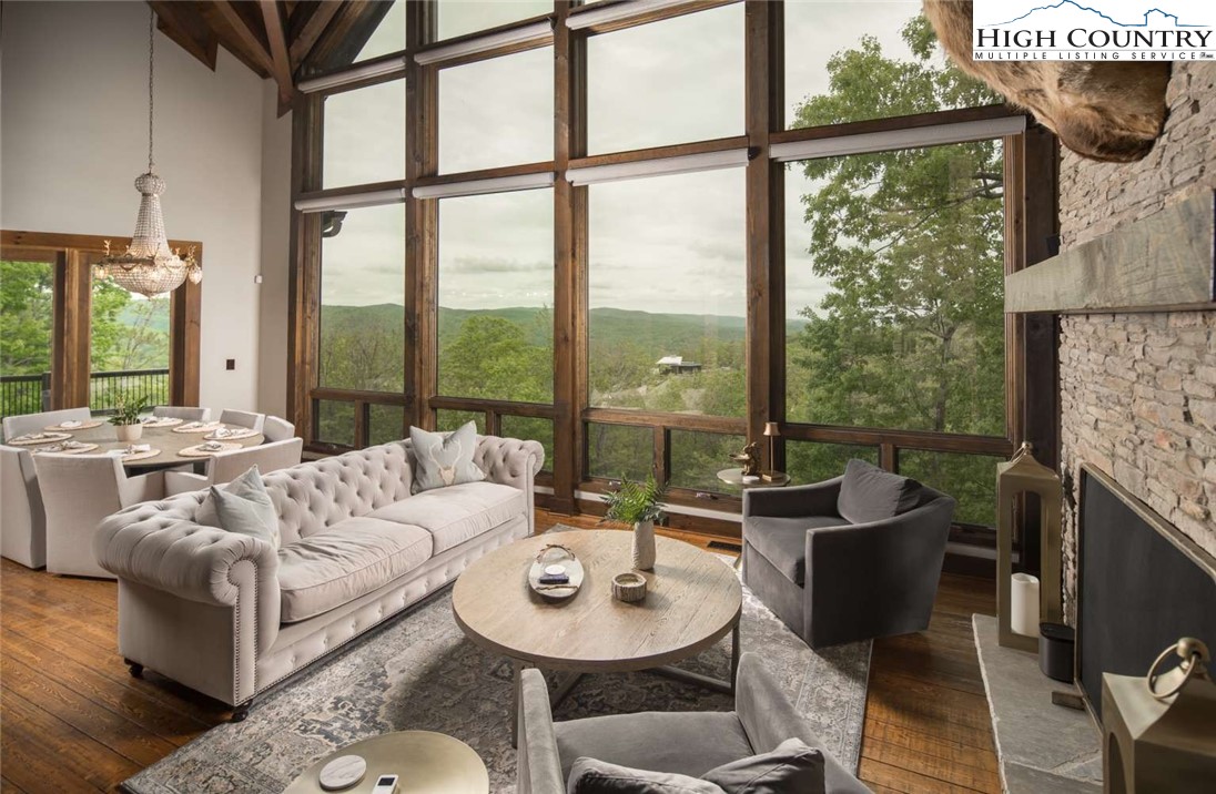 856 Ninebark Road Boone, NC 28607 - Photo 4 of 30 a living room with fireplace furniture and a floor to ceiling window