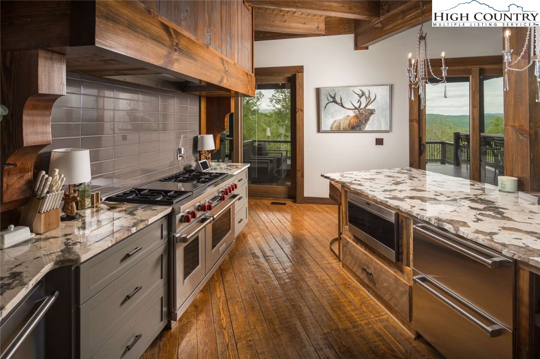 856 Ninebark Road Boone, NC 28607 - Photo 7 of 30 a kitchen with stainless steel appliances granite countertop a stove and a wooden floors